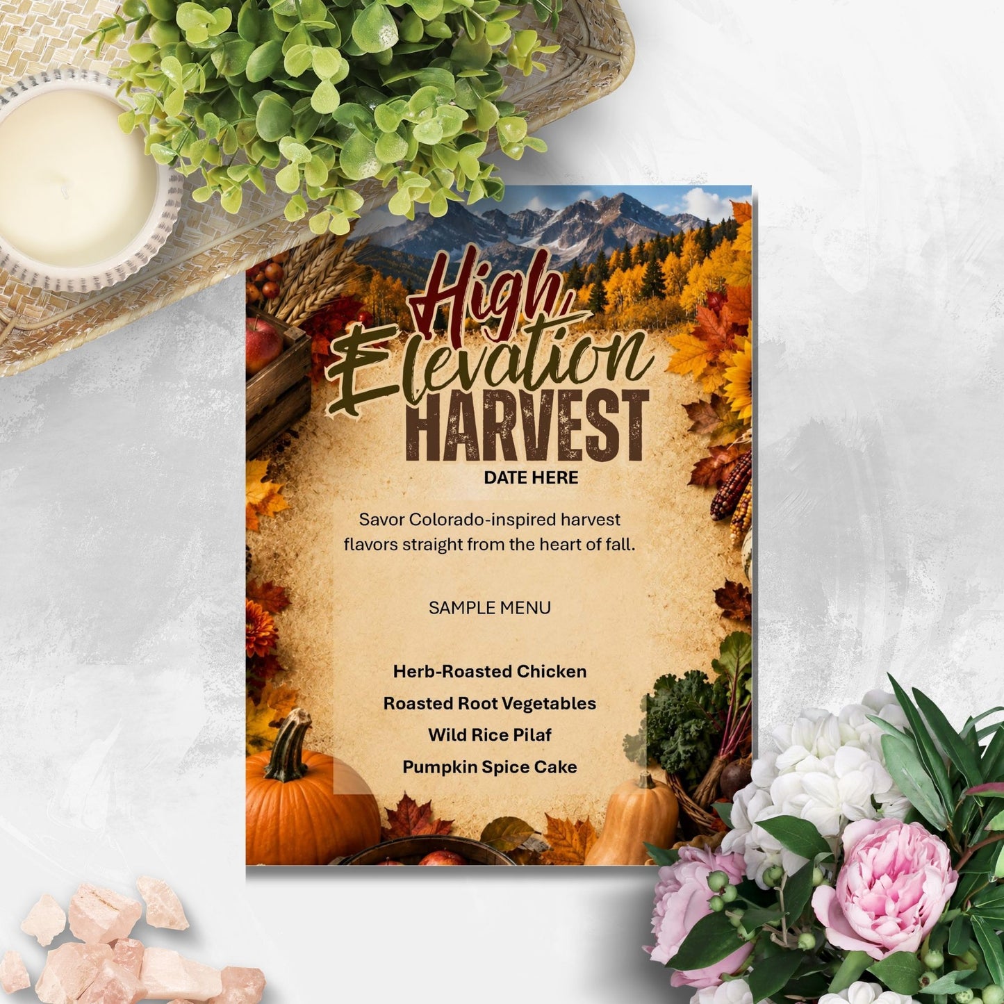 A fall harvest themed restaurant menu card styled in a flat-lay setting with a candle, green foliage, and pink flowers on a light gray textured surface.
