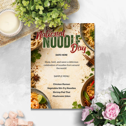 A vertical 'National Noodle Day' menu or invitation card styled in a flat-lay setting on a light gray textured surface, surrounded by green leaves, a small bowl of cream, pink stones, and pink flowers.