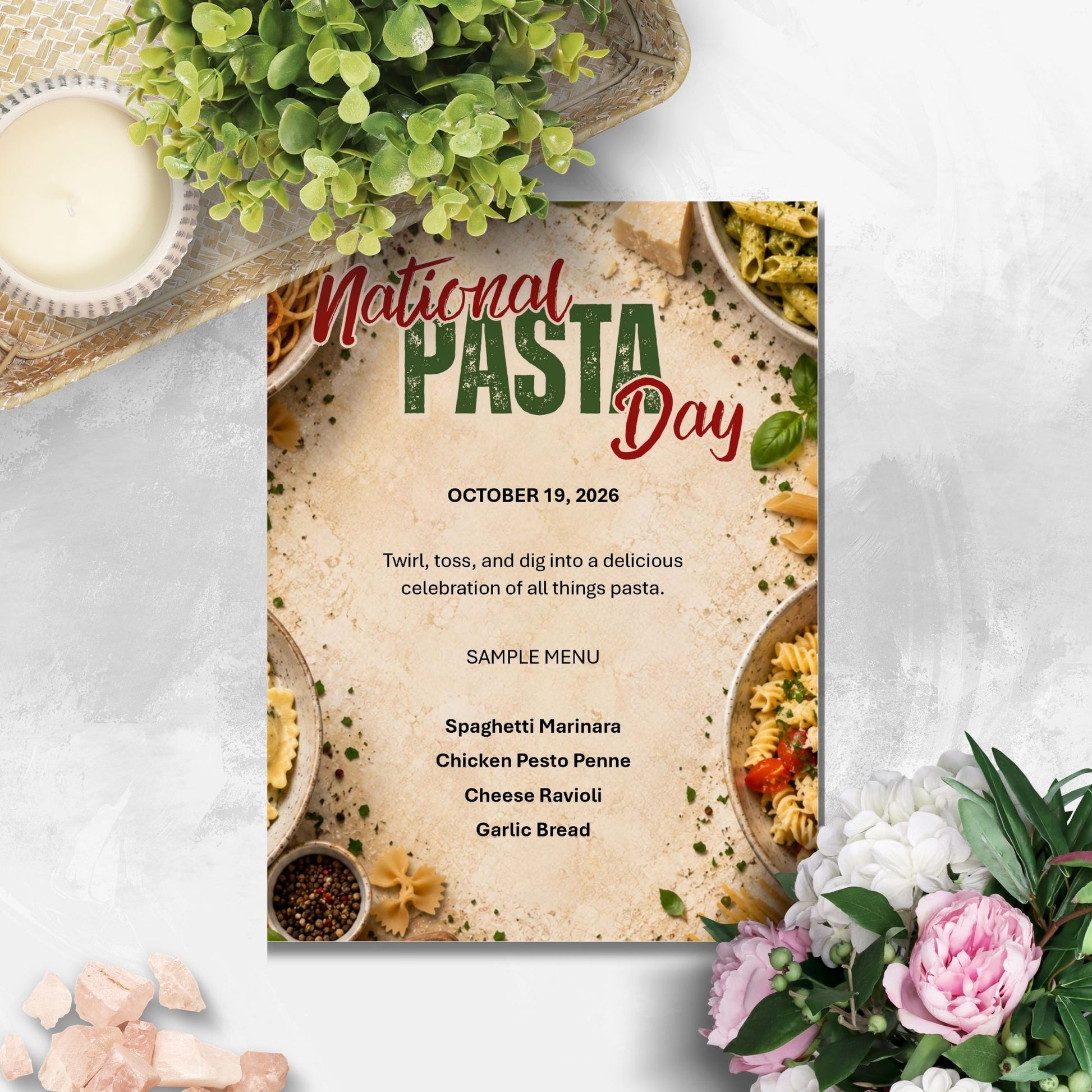 A National Pasta Day invitation card styled in a flat-lay setting with pasta bowls, greenery, and flowers on a light gray textured background.