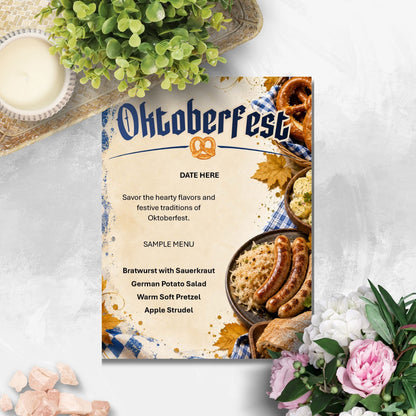 An Oktoberfest-themed printed card or menu cover is shown on a light textured surface, surrounded by decorative flowers, greenery, and a small candle. The card features the word 'Oktoberfest' with a pretzel icon and a sample menu listing beer, sausages, potato salad, pretzel, and apple strudel with food photography along the bottom.