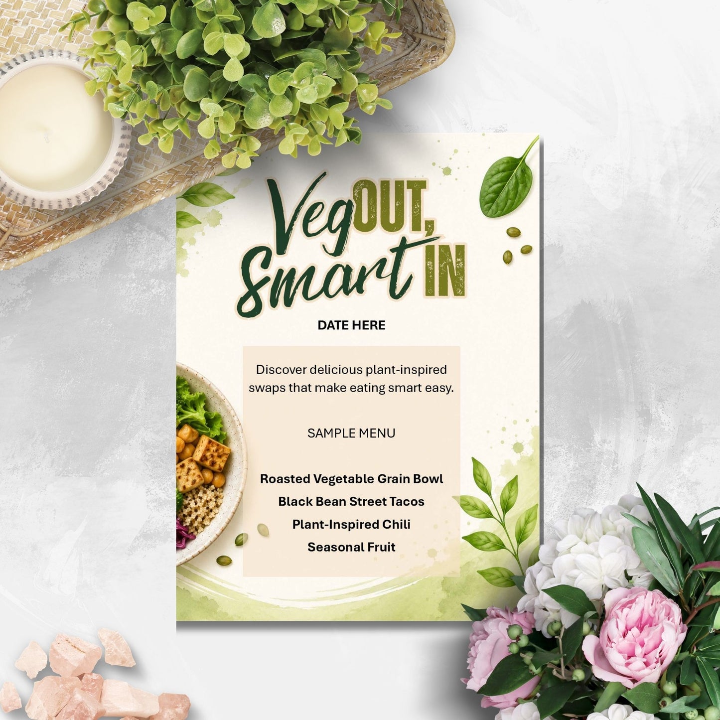 A printed menu card styled on a light stone surface with greenery and flowers around it. The card reads 'Veg OUT, Smart IN' and includes a sample plant-based menu, making this a Product/Packaging image rather than an auxiliary chart or lifestyle scene.