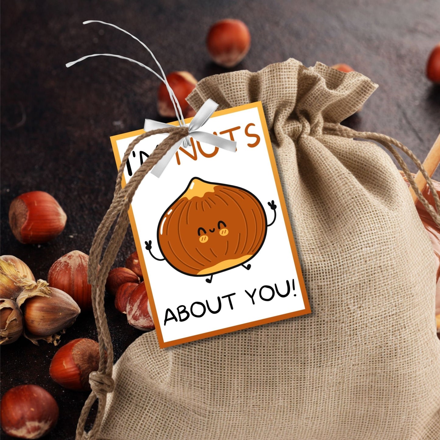 Im Nuts About You! appreciation gift tags featuring a cute cartoon hazelnut with arms, eyes, and a smile, bordered by an orange frame on a white background, ready for personalization.