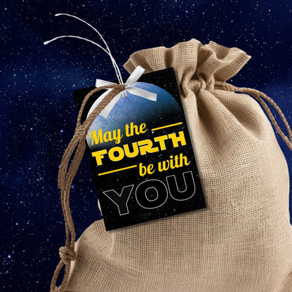 Starry space background with a vibrant Earth-like planet, featuring May the FOURTH be with YOU text for printing customizable gift tags.