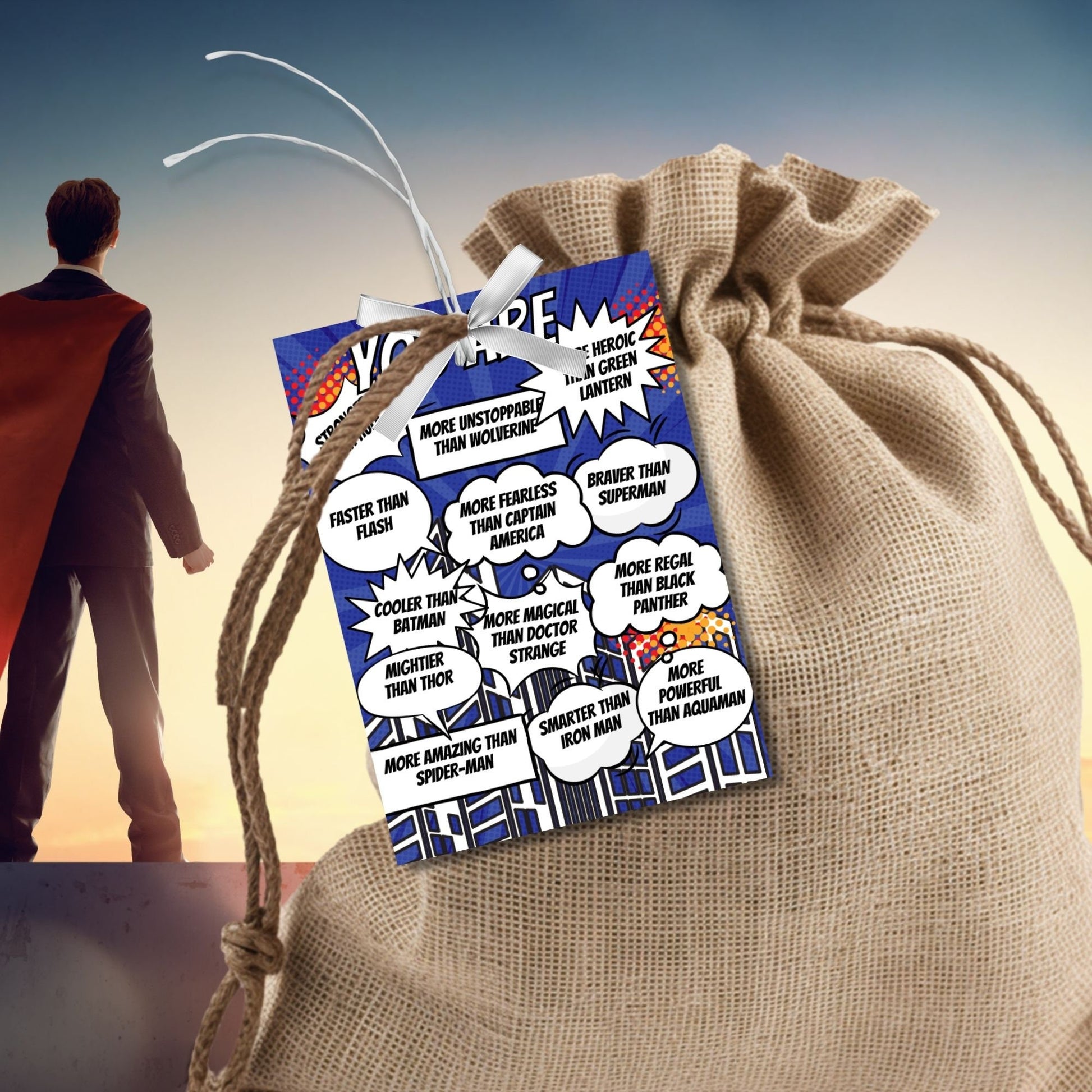 Eight comic superhero-themed Fathers Day gift tags displayed in two rows of four. Each tag features a message about how dad embodies various superhero traits, with a customizable name slot.